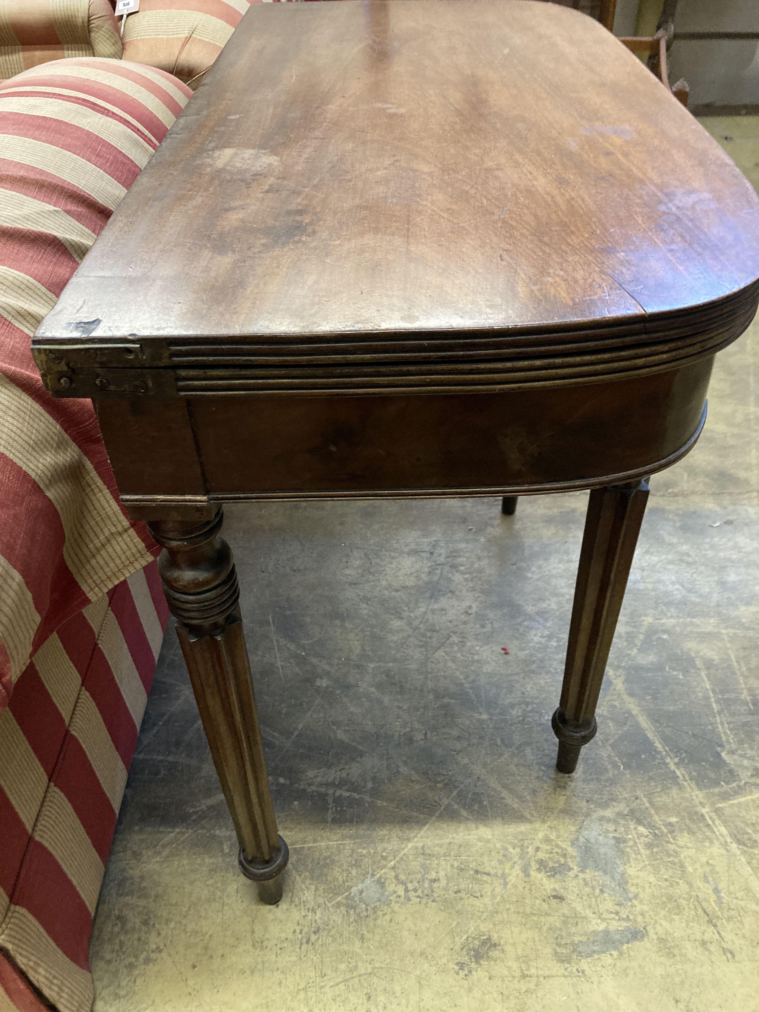 A Regency D shape mahogany folding tea table, width 93cm, depth 45cm, height 74cm